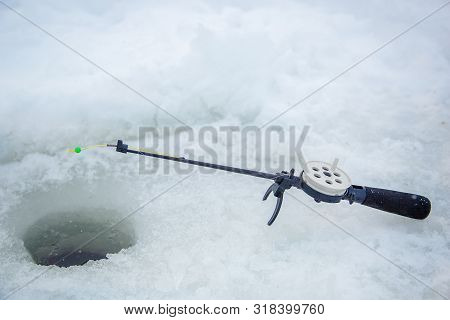 Spinning For Fishing. Ice And Fishing Rod For Winter Fishing. Winter Fishing. Small Catch Of Fish.