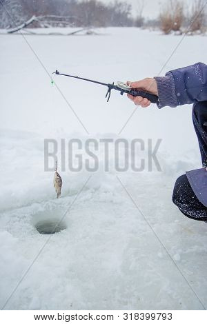 Close Up Of A Ricky Fisherman With A Fishing Rod. Ice And Fishing Rod For Winter Fishing. Winter Fis