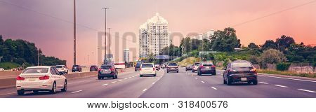 Night Traffic. Cars On Highway Road At Sunset Evening In Typical Busy American City. Beautiful Amazi