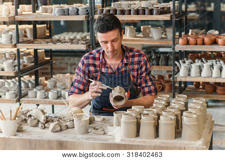 Talanted Caucasian Man Making Decoration For Cup.