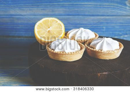 White Aircake With Lemon Filling And Lemon On A Wooden Table