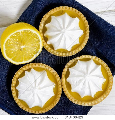 White Aircake With Lemon Filling And Lemon On A Wooden Table