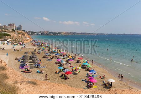 Playa Vistamar Beach Mil Palmeras Costa Blanca Spain With People Sunbathing On The Beach In Beautifu