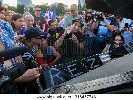 Bucharest, Romania - August 10, 2019: Davide Martello Cools Off With Water While Plays The Piano Dur