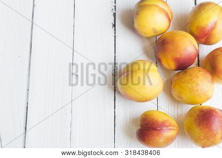 Delicious And Juicy Peach (nectarina) On White Wooden Table With Place For Text.