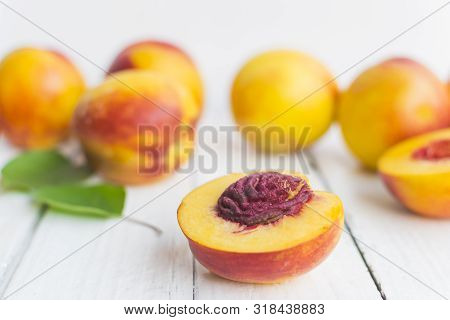 Delicious And Juicy Peach (nectarina) On White Wooden Table With Place For Text.