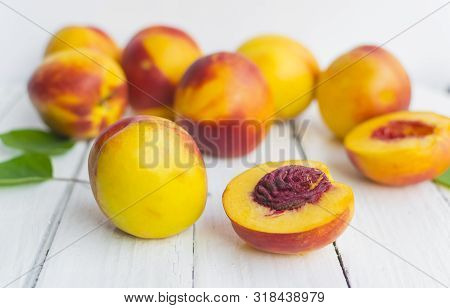 Delicious And Juicy Peach (nectarina) On White Wooden Table With Place For Text.