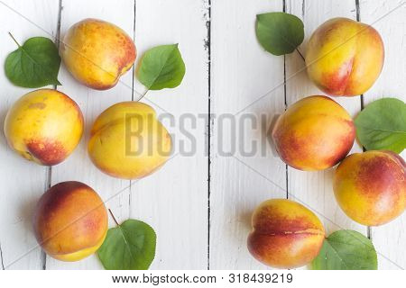 Delicious And Juicy Peach (nectarina) On White Wooden Table With Place For Text.