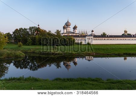 View To Tikhvin Assumption (bogorodichny Uspensky)  Monastery With Reflection In River. Tikhvin, Len