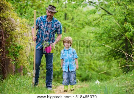 Planting Flowers. Dad Teaching Little Son Care Plants. Little Helper In Garden. Make Planet Greener.