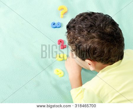 Little Boy At Preschool Learning Numbers Playing With Various Toy Numbers And Shapes Stock Image And