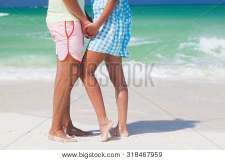 Legs Of Young Hugging Couple On Tropical Turquoise Beach. Cayo Largo, Cuba