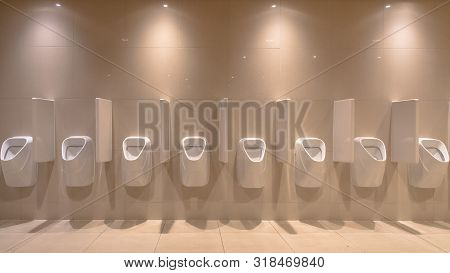 Row Of Modern Urinals In New Bathroom Of Theater