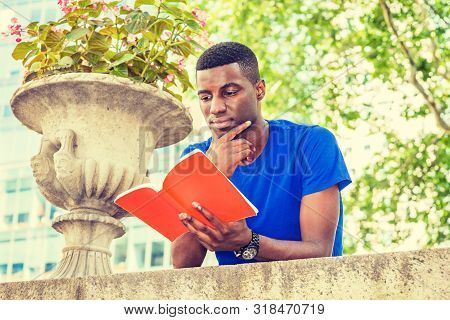 Young African American College Student Studying In New York, Wearing Blue Short Sleeve T Shirt, Stan