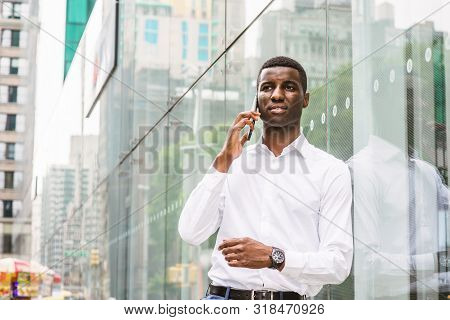 Young African American Man Talking On Cell Phone, Traveling In New York, Wearing White Long Sleeve S