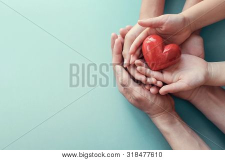 Adult And Child Hands Holding Red Heart On Aqua Background, Heart Health, Donation, Csr Concept, Wor