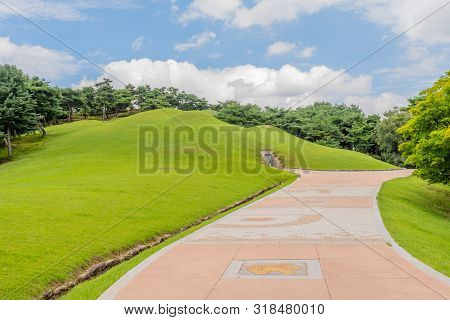 Gongju, South Korea; July 29, 2019: Concrete Walkway Leading To Entry Of Songsan-ri Tombs At First D