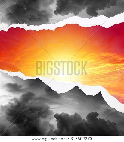 Hole ripped in stormy sky to a bright sky. Bright future. 