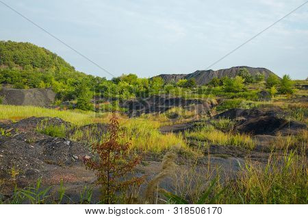 The Industrial Landscape Consists Of Heaps And Scattered Rock Masses.