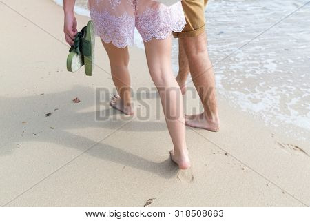 couple wallking on the sandy beach