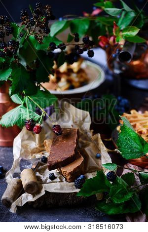 Norwegian Cheese Brunost On The Cutting Board .style Rustic.selective Focus