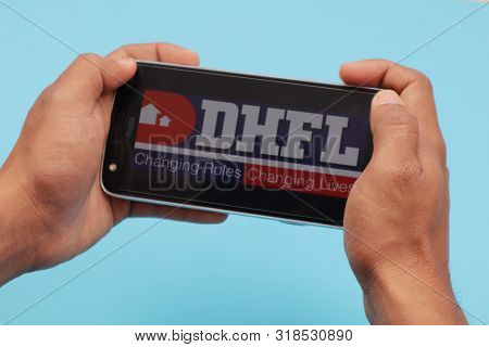Maski India, 23 August, 2019 : Hands Holding Mobile With Dhfl Bank Website Logo Loading On Mobile.