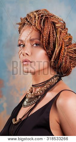 Southern Flavor. Portrait Of A Luxurious Tanned Woman, Pensive, Stylish, With An Exotic Hairstyle An