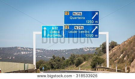 Blue Road Sign On A22 Highway Indicating The Direction Of Lisbon, Portugal