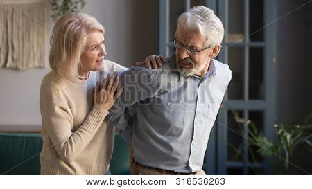 Worried Mature Wife Supporting Senior Husband Feel Sudden Back Pain