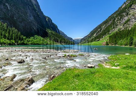 Fast Water Stream Flow Into Mountain Lake. Summer Mountain Landscape In The Alps, Austria, Tyrol.