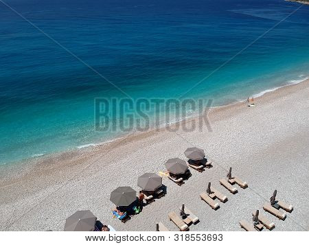 Aerial View Rocky Beach And Crystal Turquoise Water Of Ionian Sea In Albania. Calm And Relaxing View