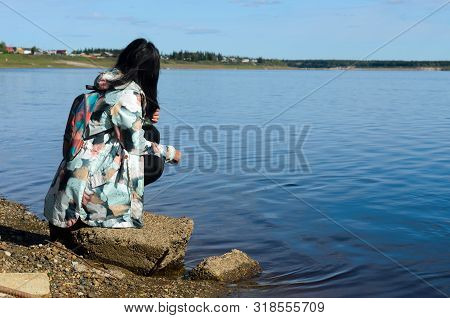 Modern Sad Girl Yakut Looks At The Village Of Ulus Suntar Near The River Vilyu Contaminated With Was