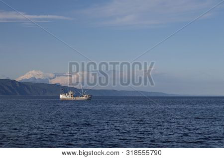 View Of Lake Baikal Near The City Of Slyudyanka, Irkutsk Region, Russia. Landscape With A Fishing Bo