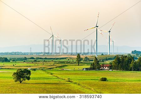 Wind Turbines On The Field In Rural Area. Ecology Concept