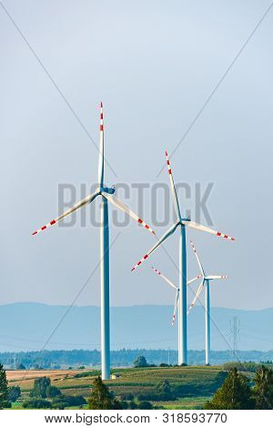 Wind Turbines On The Field In Rural Area. Ecology Concept