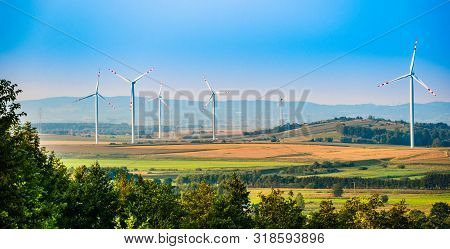 Wind Turbines On The Field In Rural Area. Ecology Concept