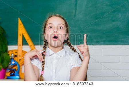 Girl Cute Child Sit School Classroom Chalkboard Background. Small Kid Study School. Knowledge Day. H