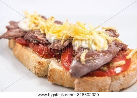 Detail Of A Toast Of Iberian Pork Sirloin On A Natural Tomato Base