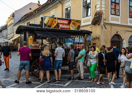 Brasov, Romania - 2019. Tourists Waiting In Line To Buy Kurtos Kolacs.