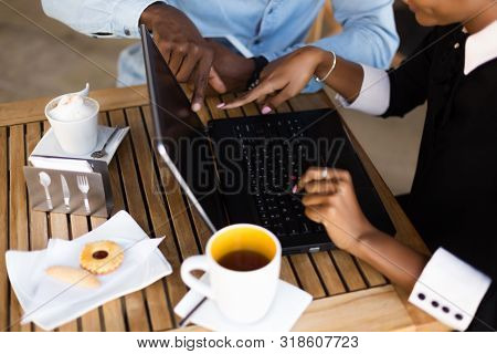 Black  African American Coworkers Doing Digital Teamwork Arround A Coffee Cup
