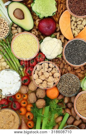 Vegan health food with sos mix, fruit, vegetables, peanut butter, almond yoghurt, nuts, seeds, grains, legumes, almond milk and yoghurt. Super foods high in antioxidants, protein and dietary fibre.  