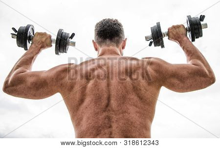 Strength And Motivation. Man Sportsman Weightlifting. Steroids. Athletic Body. Dumbbell Gym. Muscula