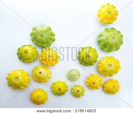 Pattypan Squashes Vegetable. Group Of Green And Yellow Pattypan Squashes, On White Table Background.