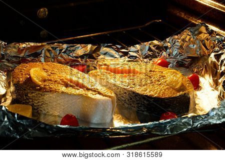 Cooking Fish In The Oven. Two Pieces Of Salmon In Foil Baked In The Oven