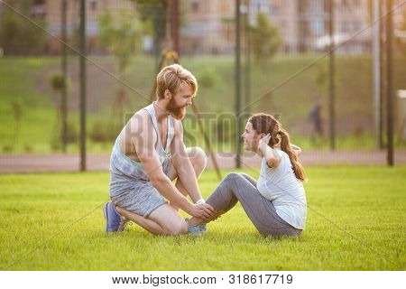 Sit Ups Fitness Couple Exercising Sit Up Outside In Grass. Fit People Working Out Cross Training. Wo