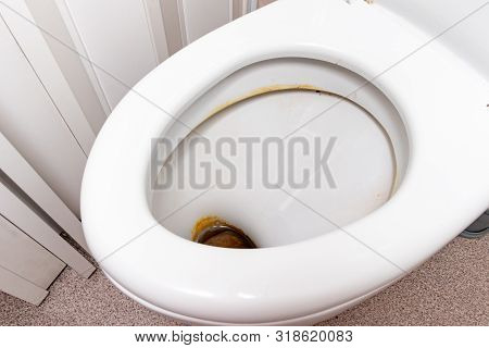 Dirty Unhygienic Toilet Bowl With Limescale Stain At Public Restroom Close Up