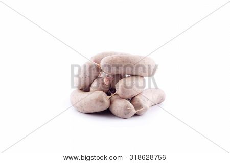 Fresh Pork Meat Wrapped In Guts, Homemade Raw Sausages On A White Background , Isolated Close-up