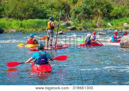 Myhiya, Ukraine - August 17, 2019: Athletes Kayakers During Training On Whitewater. Man On Inflatabl