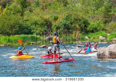 Myhiya, Ukraine - August 17, 2019: Athletes Kayakers During Training On Whitewater. Man On Inflatabl
