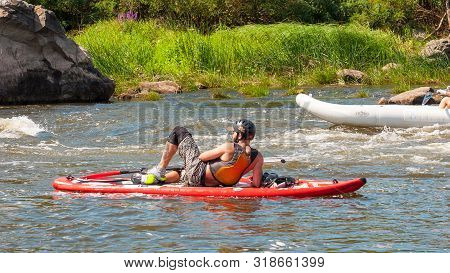 Myhiya, Ukraine - August 17, 2019: Athletes Kayakers During Training On Whitewater. Man On Inflatabl